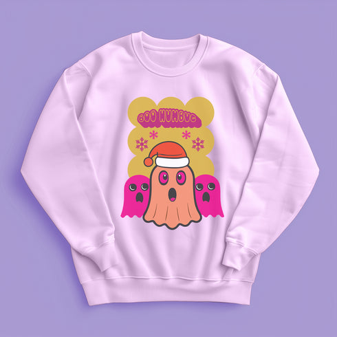 A holiday sweatshirt featuring a cute ghost character wearing a Santa hat, with two smaller ghosts on either side. Above them is the playful text "Boo Humbug," surrounded by snowflakes and festive elements. The design humorously combines spooky and festive themes for a unique holiday look.